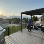 Composite deck and covered pergola outdoor living space on a Utah backyard at golden hour