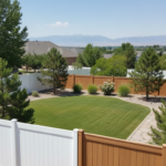 White vinyl and wood-look composite privacy fences in a Utah backyard