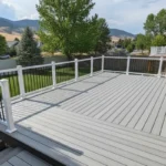A newly rebuilt composite deck beside a Utah home with mountain scenery in the background